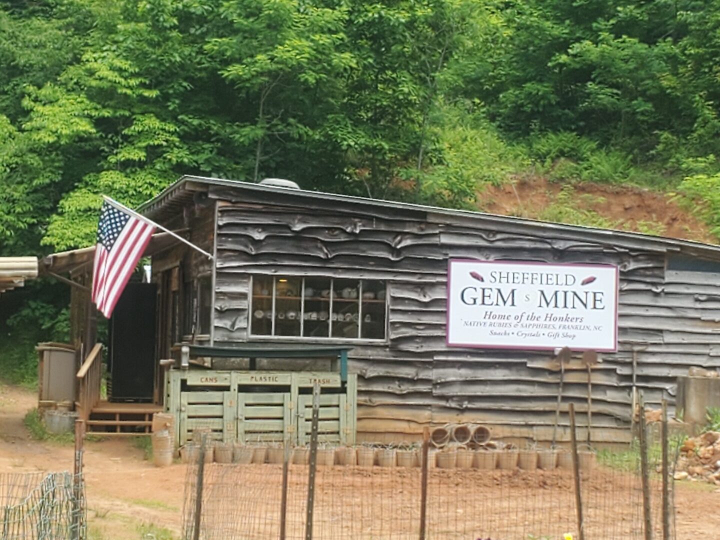 A log cabin with an american flag on the front.
