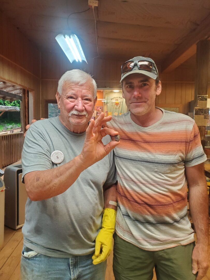 A man and an older gentleman holding bananas.