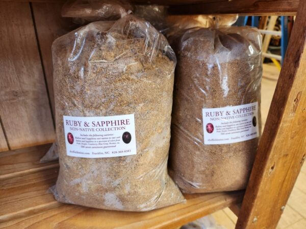 A couple of bags of wood shavings on top of a shelf.