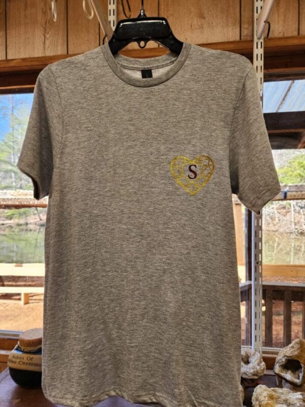 A gray t-shirt with a yellow heart on the front.