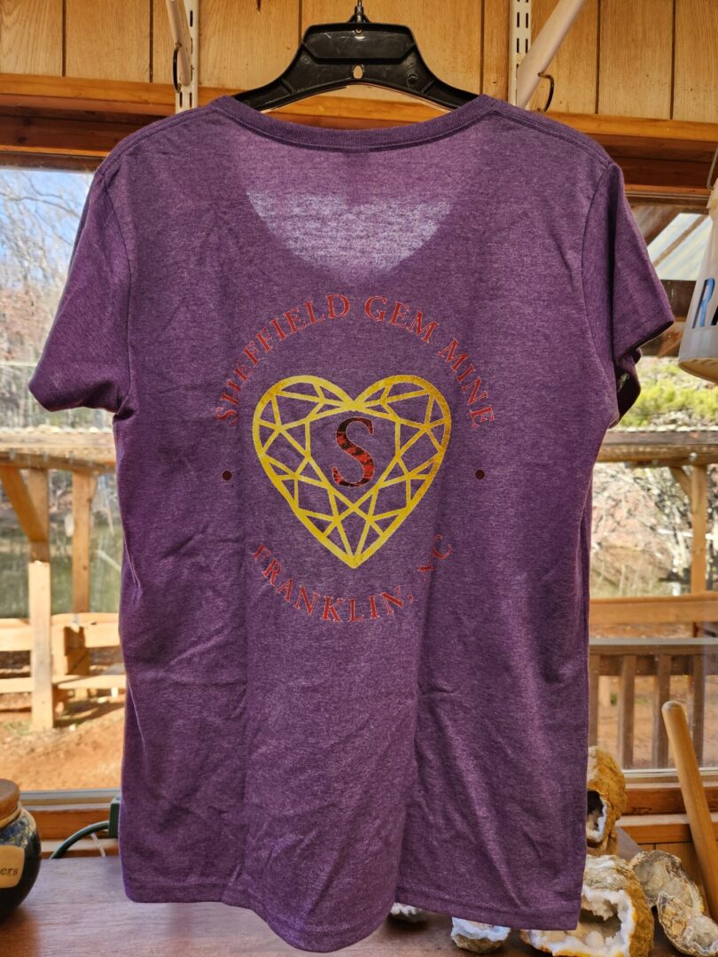 A purple shirt with a heart on it