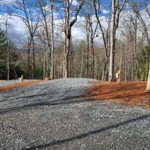 A gravel road with trees in the background.