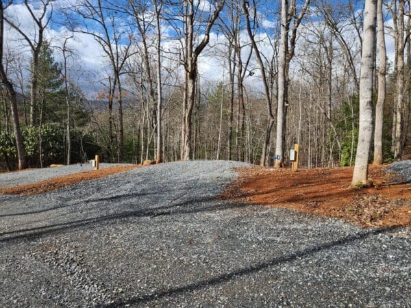 A gravel road with trees in the background.