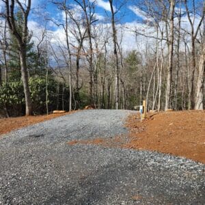 A gravel road in the middle of a wooded area.