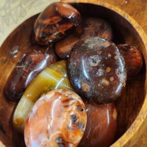 A wooden bowl filled with different types of food.