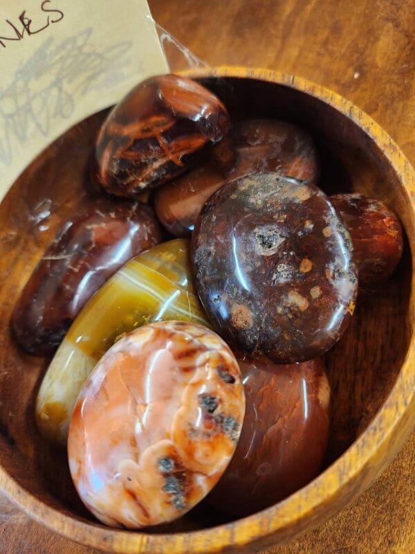 A wooden bowl filled with different types of food.