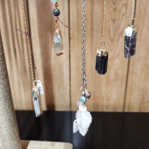 A table with some hanging crystals and other items