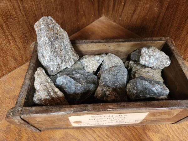 A wooden box filled with rocks on top of the floor.