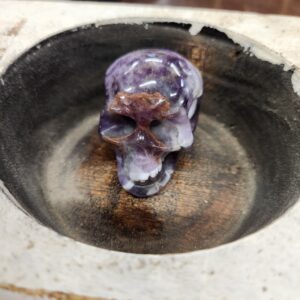 A purple skull in the middle of a bowl.