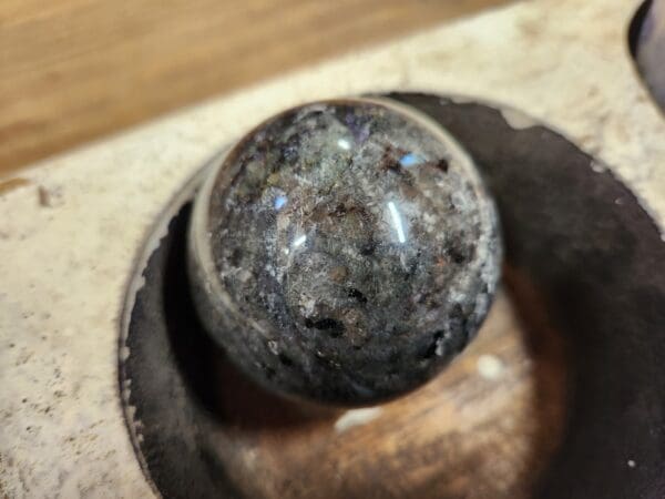 A close up of a ball on top of a wooden surface.