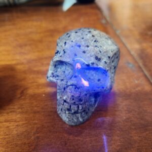 A skull with blue light on it's face.