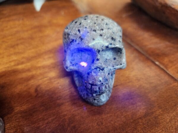 A skull with blue light on it's face.