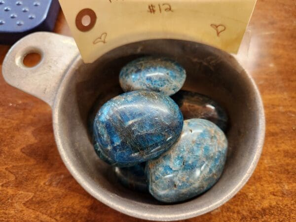 Blue kyanite tumbled stones in a bowl.